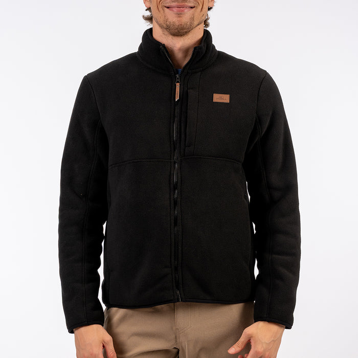 Man wearing a black jacket with a visible brand logo on a white background