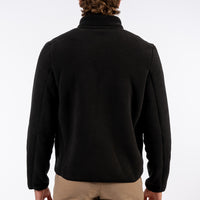 Person wearing a black jacket on a white background