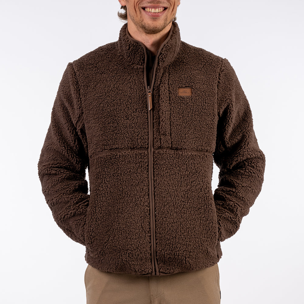 Man wearing a brown fleece jacket on a white background