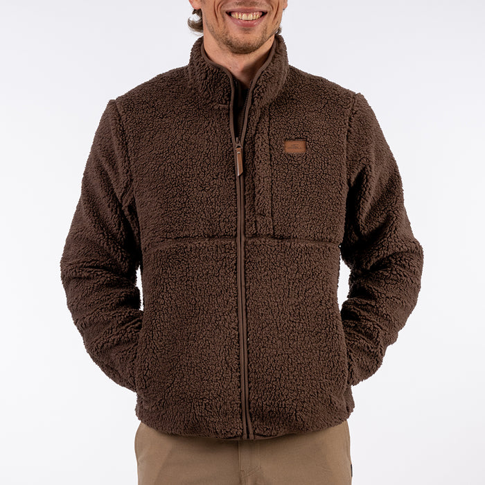 Man wearing a brown fleece jacket on a white background