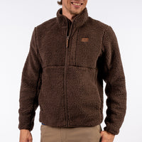 Man wearing a brown fleece jacket on a white background