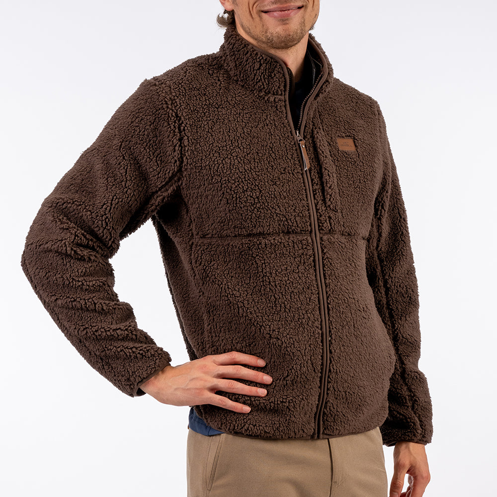 Man wearing a brown fleece jacket on a white background