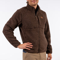 Man wearing a brown fleece jacket on a white background