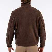 Brown fleece jacket worn by a person on a white background