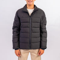 Person wearing a black puffer jacket on a white background