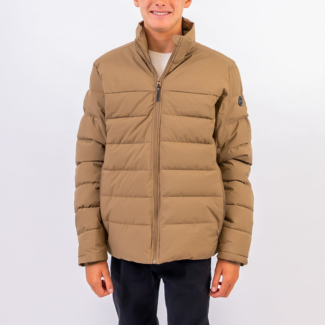 Person wearing a beige puffer jacket on a white background