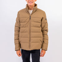 Person wearing a beige puffer jacket on a white background