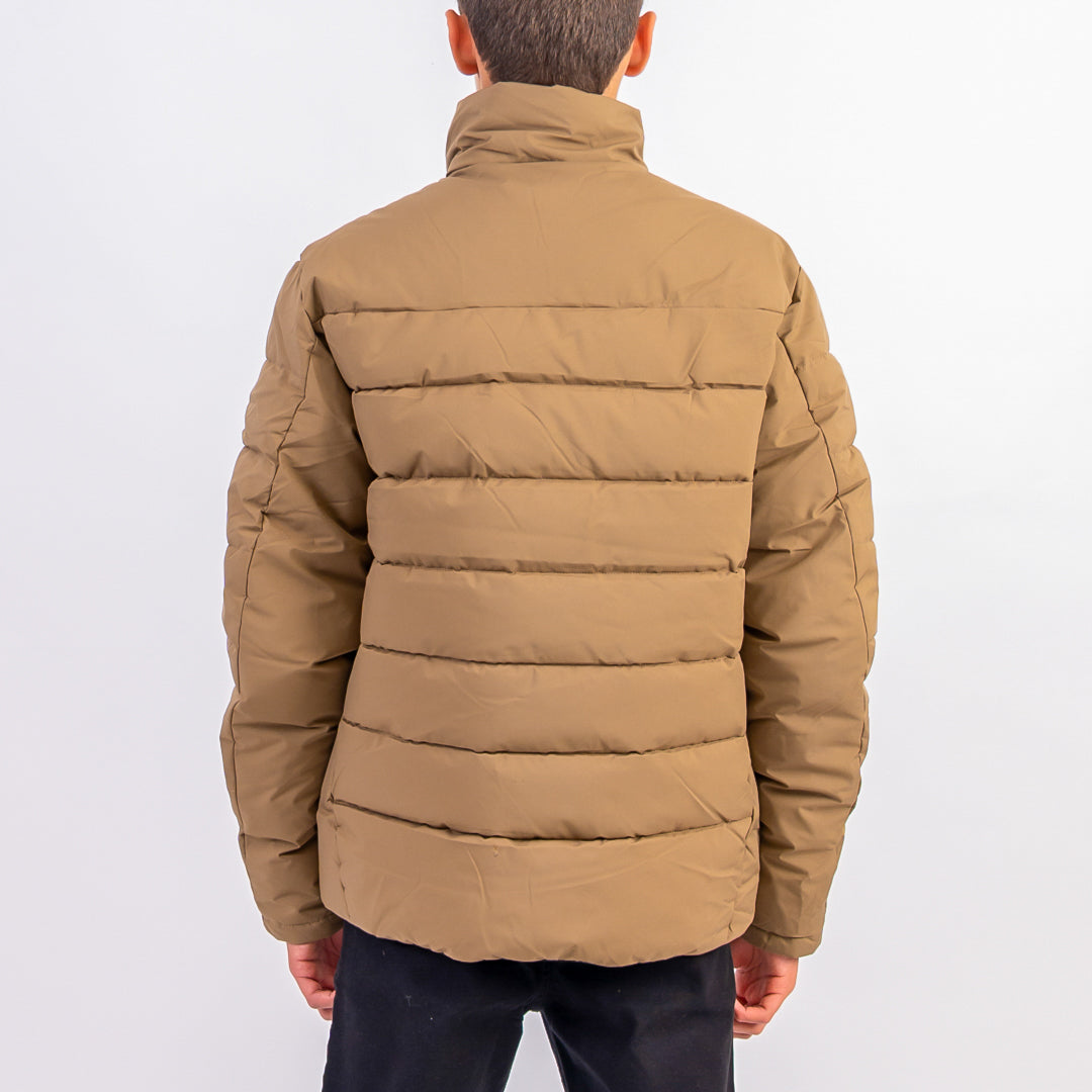 Brown puffer jacket worn by a person on a white background