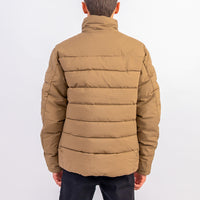 Brown puffer jacket worn by a person on a white background