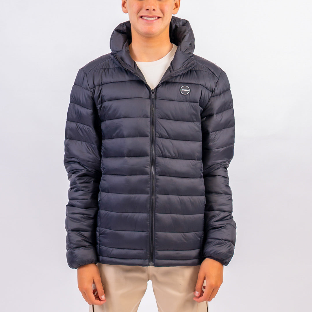 Person wearing a dark blue puffer jacket on a light gray background