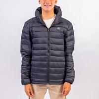 Person wearing a dark blue puffer jacket on a light gray background