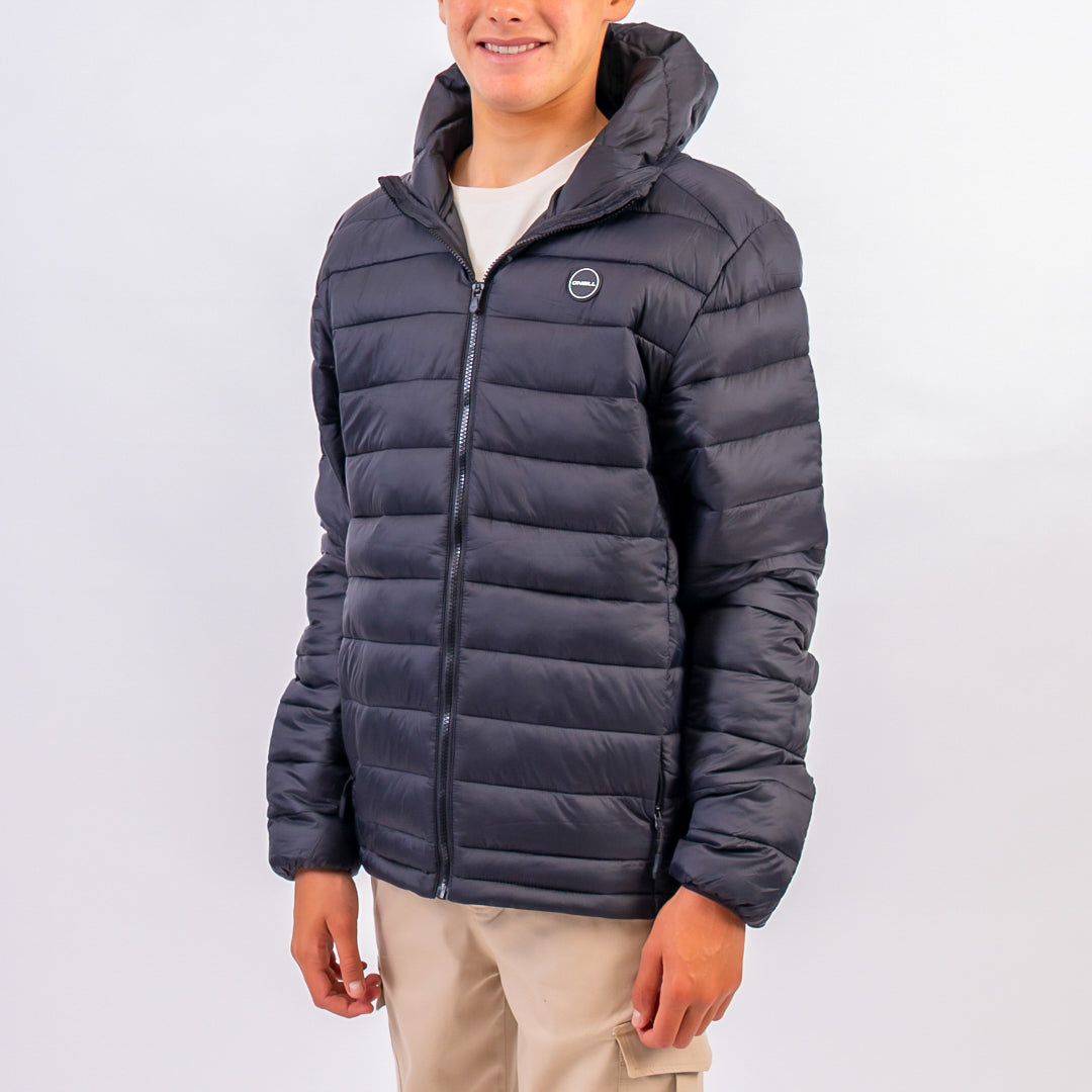 Person wearing a dark blue puffer jacket on a white background