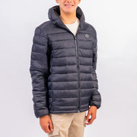 Person wearing a dark blue puffer jacket on a white background