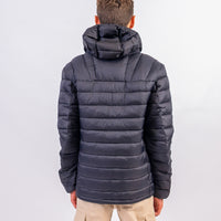 Person wearing a dark blue puffer jacket on a white background