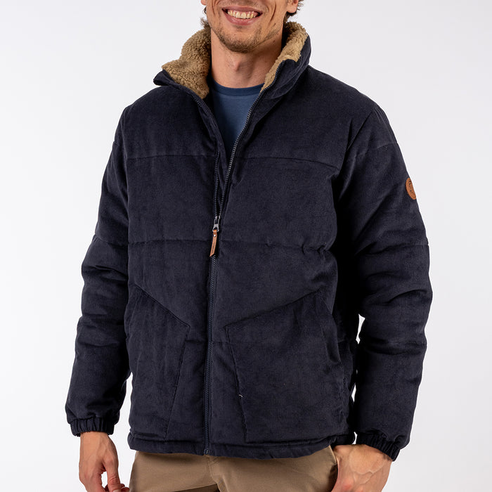 Man wearing a dark blue jacket with brown lining on a white background