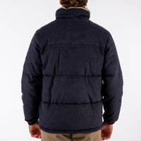 Navy puffer jacket worn by a person on a white background