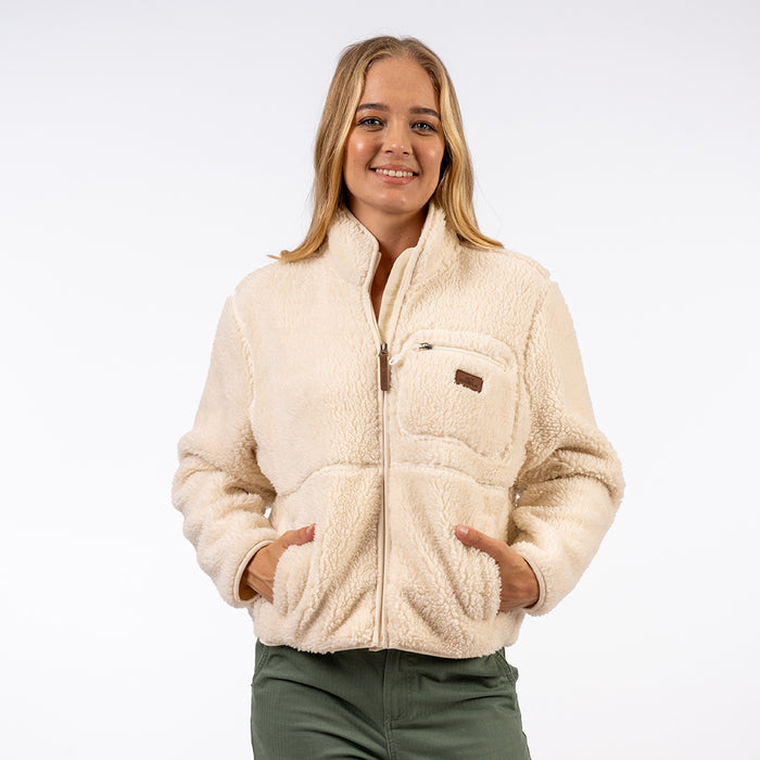 Woman wearing a beige sherpa jacket on a white background