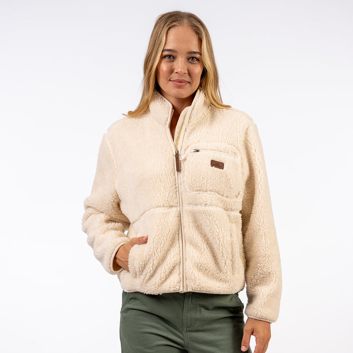 Woman wearing a cream sherpa jacket with a brand logo on a white background