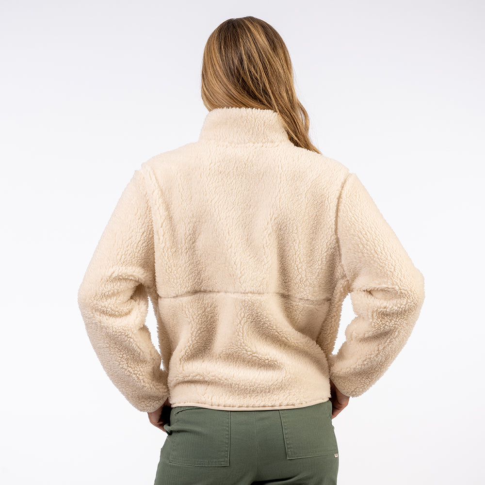 Person wearing a beige fleece jacket on a white background