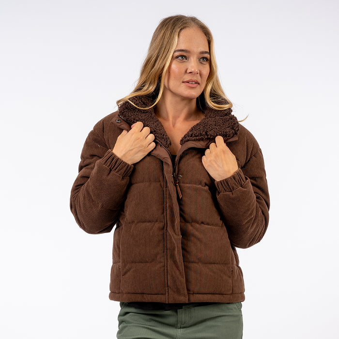 Woman wearing a brown puffer jacket on a white background