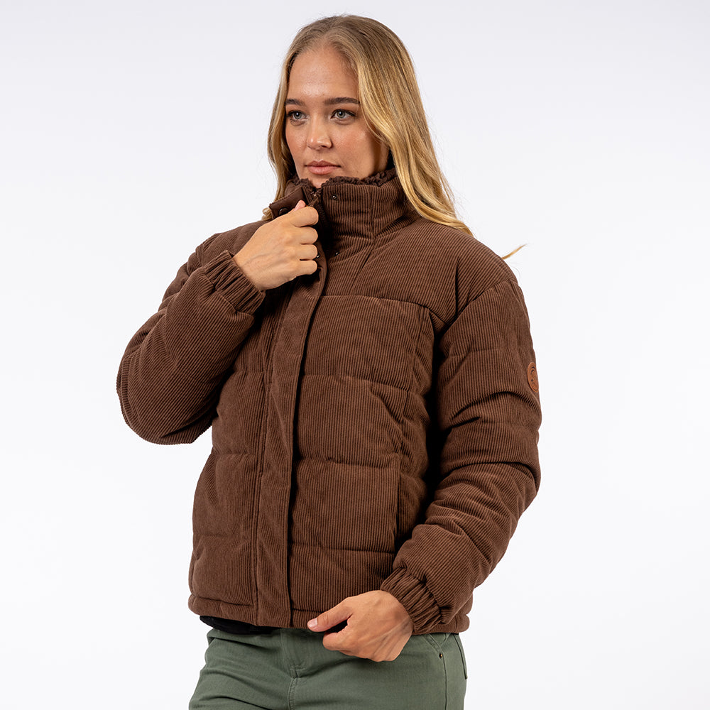Woman wearing a brown puffer jacket on a white background