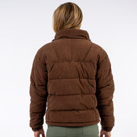 Brown puffer jacket worn by a person on a white background