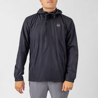 Person wearing a black jacket with a brand logo on a light gray background