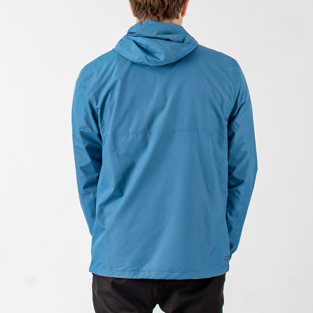 Blue jacket worn by a person on a white background