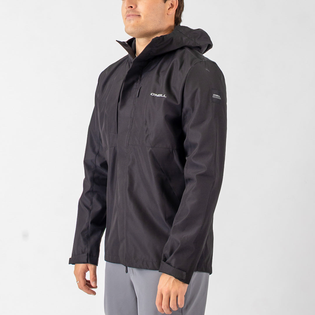 Person wearing a black jacket with a visible brand logo on a white background