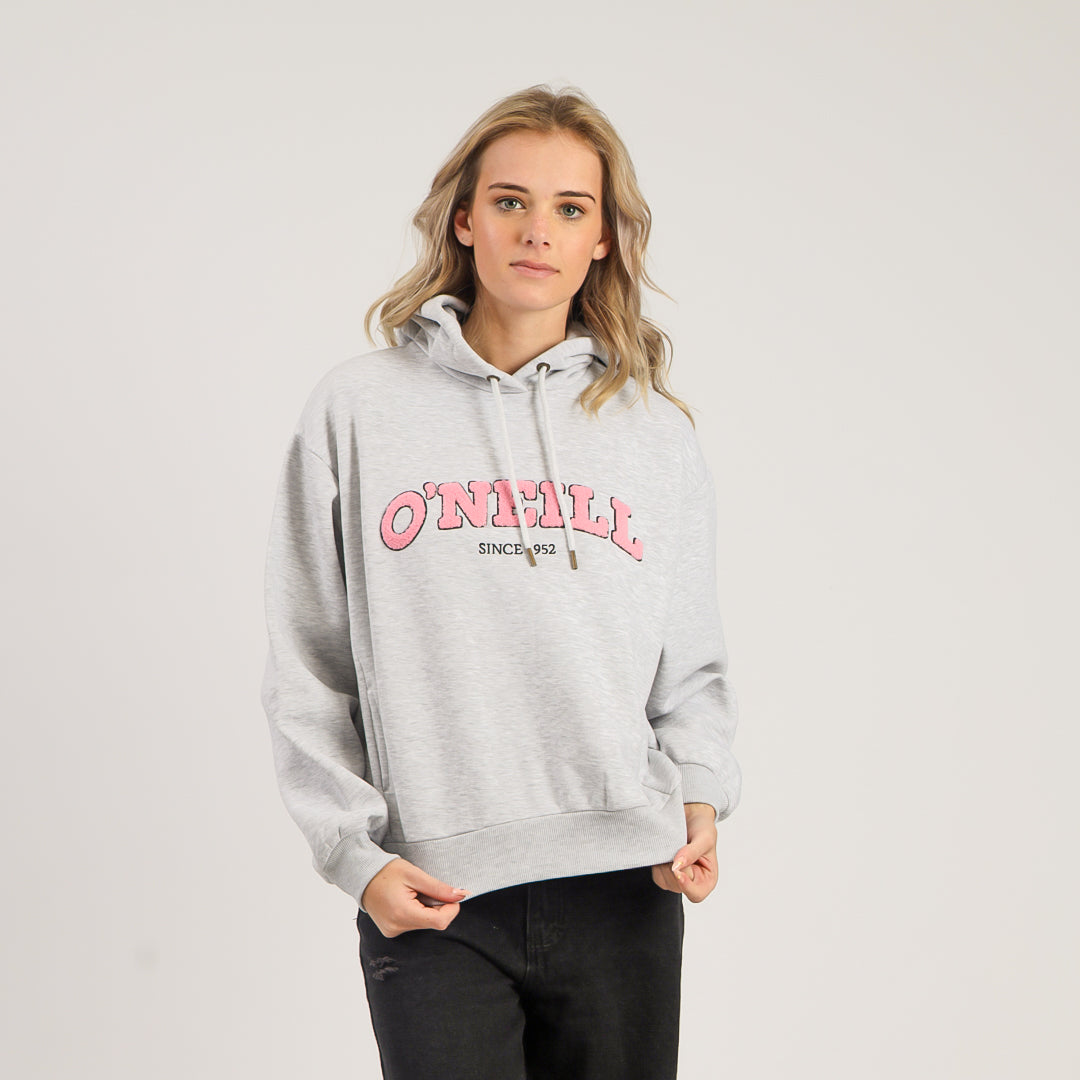 Person wearing a gray hoodie with pink text on a light gray background