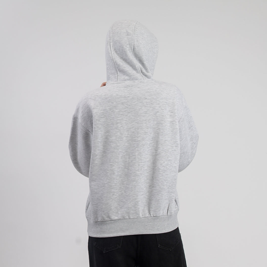 Person wearing a gray hoodie on a light gray background