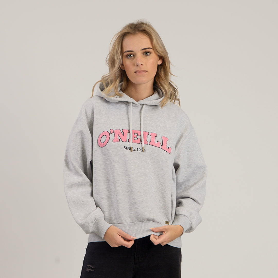 Person wearing a gray hoodie with pink text on a plain background