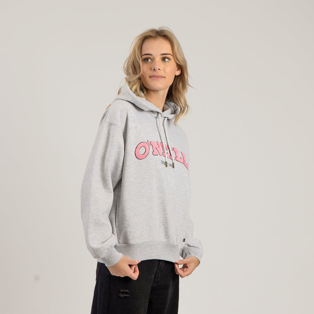 Person wearing a gray hoodie with pink text on a plain background