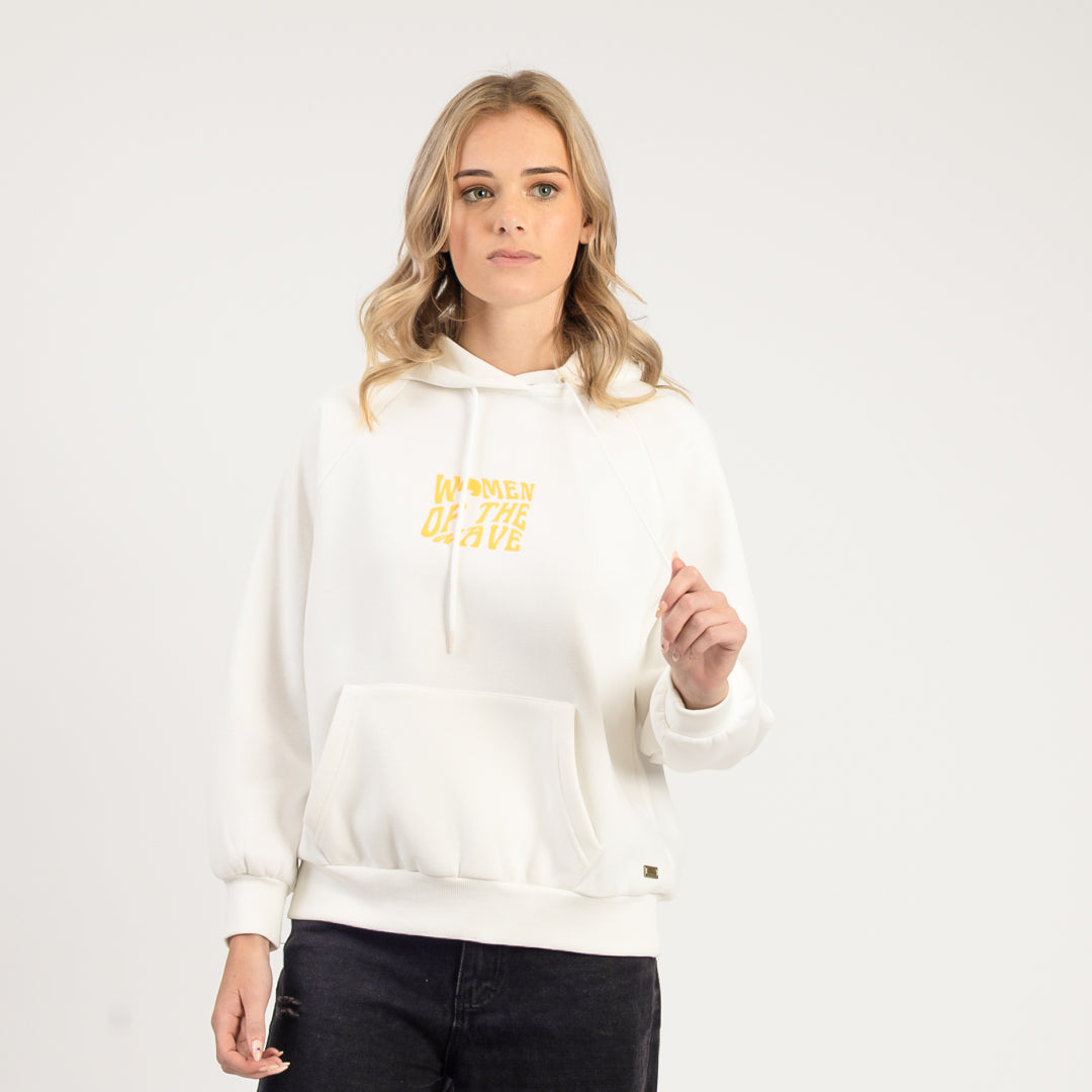 Person wearing a white hoodie with yellow text on a plain background