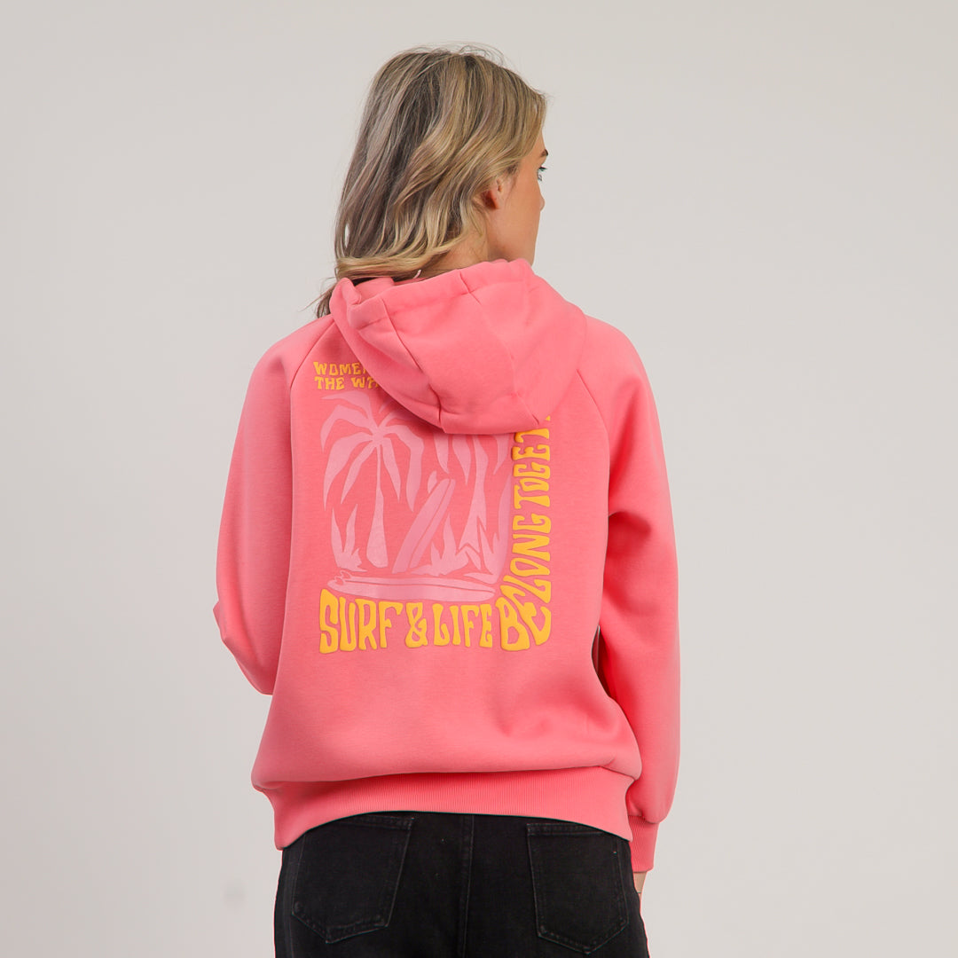 Person wearing a pink hoodie with yellow text and graphics on a plain background