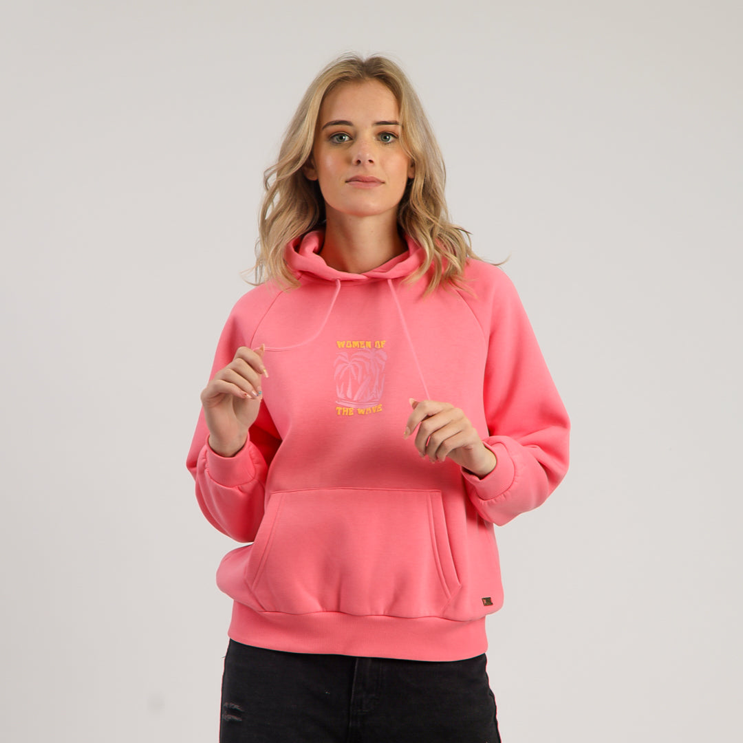 Person wearing a pink hoodie with a logo on a plain background