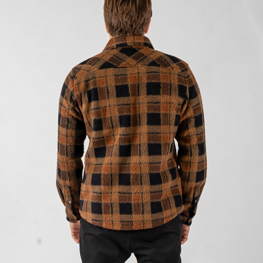 Person wearing a plaid shirt with a white background