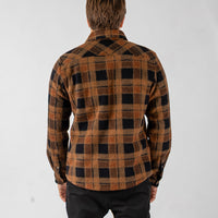 Person wearing a plaid shirt with a white background