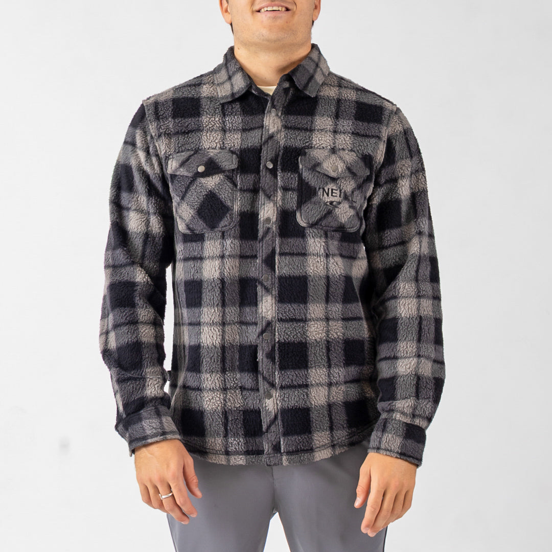 Person wearing a gray and black plaid shirt on a white background