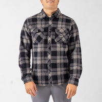 Person wearing a gray and black plaid shirt on a white background