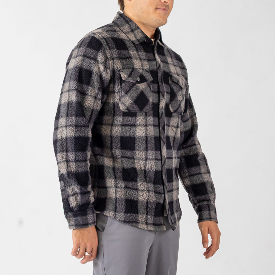 Person wearing a plaid shirt on a white background