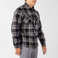 Person wearing a plaid shirt on a white background