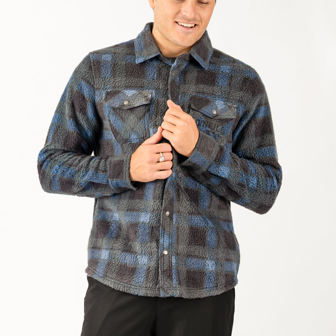 Person wearing a blue and gray plaid shirt on a white background