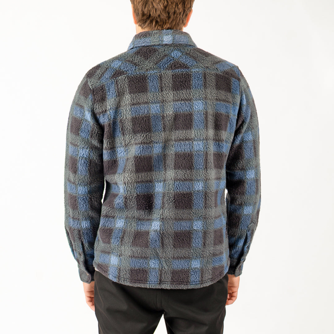 Person wearing a blue and gray plaid shirt on a white background