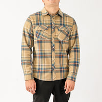 Person wearing a plaid shirt with a neutral color palette on a white background