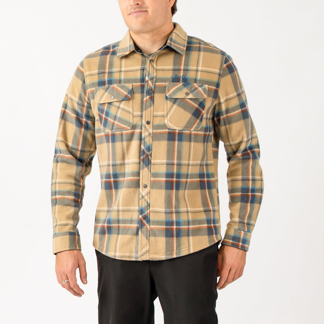 Man wearing a plaid shirt with a neutral background