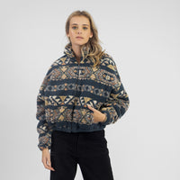 Woman wearing a patterned sweater against a white background