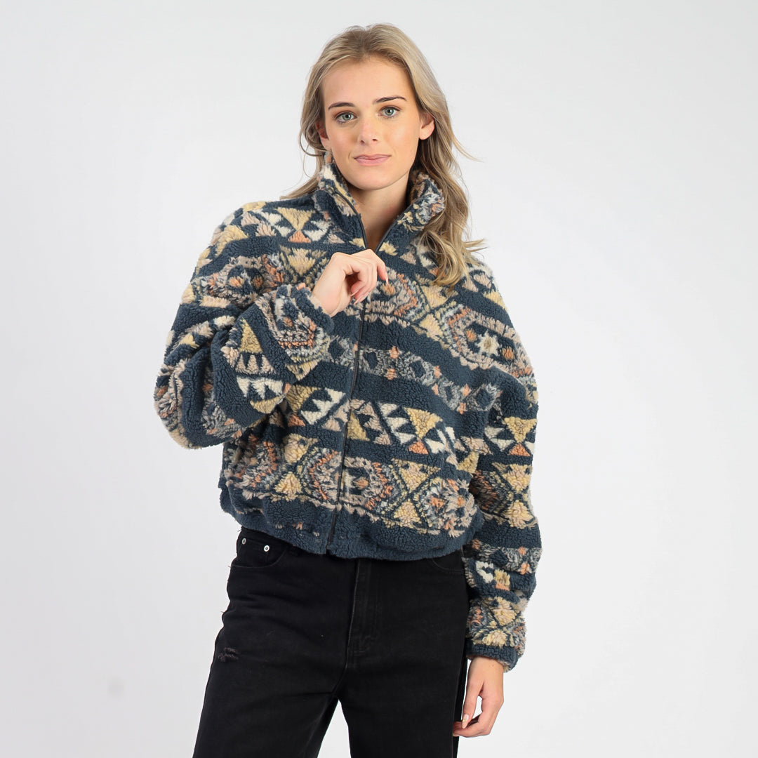 Woman wearing a patterned sweater on a white background