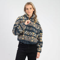 Woman wearing a patterned sweater on a white background