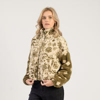Woman wearing a floral patterned jacket on a white background